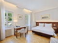 Suite bedroom with bed and desk | Hotel Altstadt in Salzburg