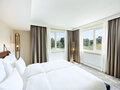 Junior Suite with double bed and view into the green