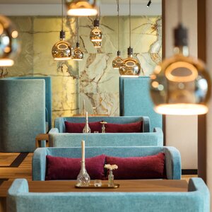 View of tables in the restaurant/lounge area at the Hotel Maximilian