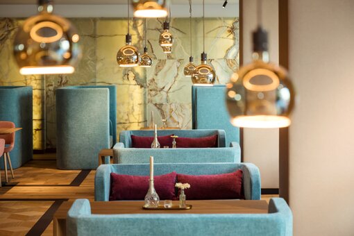 View of tables in the restaurant/lounge area at the Hotel Maximilian