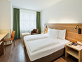 Classic Room with twin bed, desk and seating | Hotel Theresianum in Vienna