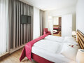 Junior Suite bedroom with view into the living room | Hotel Theresianum in Vienna