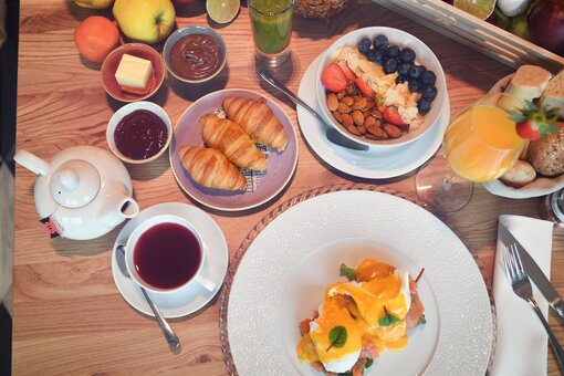 View from above of a richly laid breakfast table.