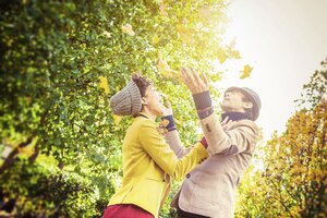 Herbst Menschen werfen Blätter in die Luft